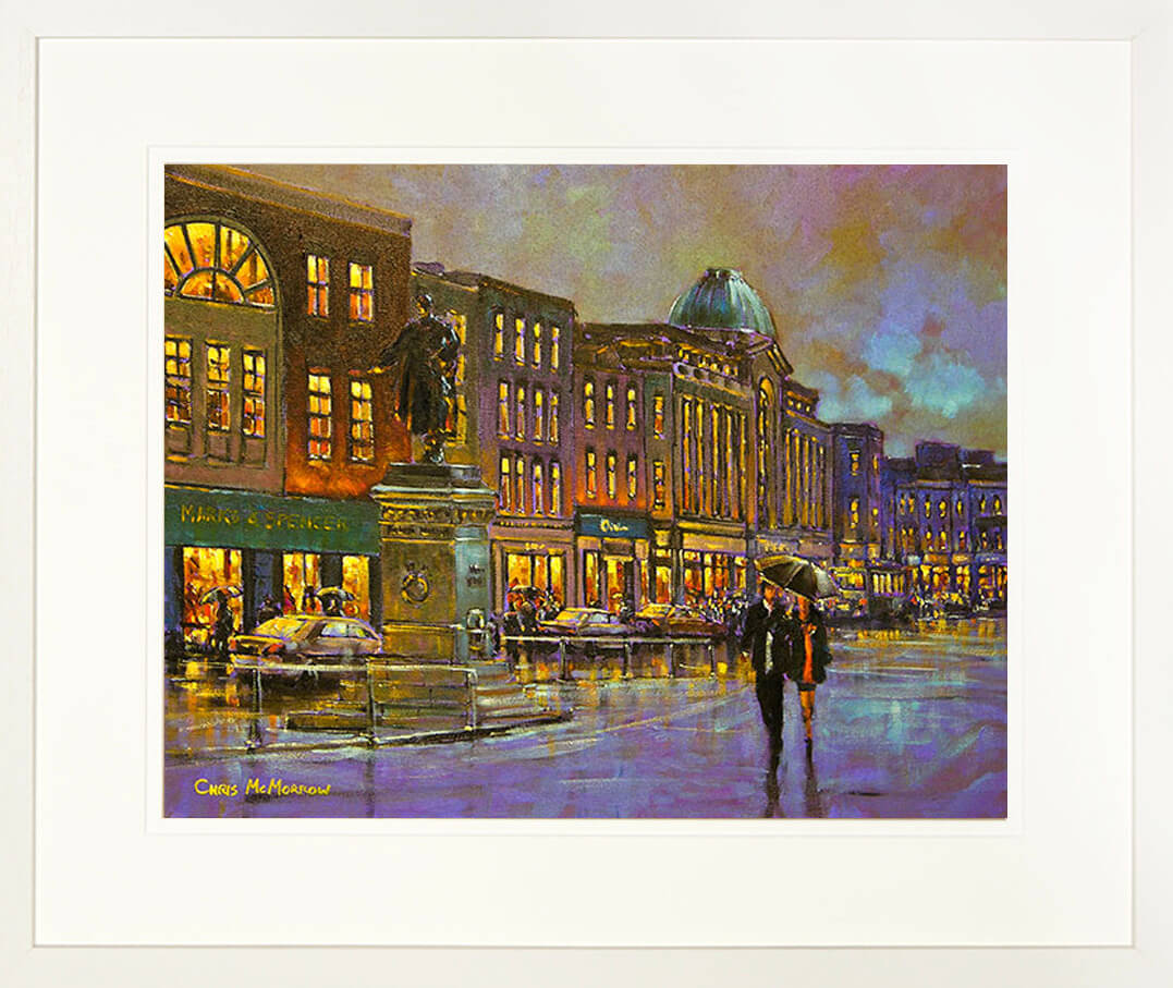 A framed print of a colourful painting of people out shopping on Patrick street. Cork city