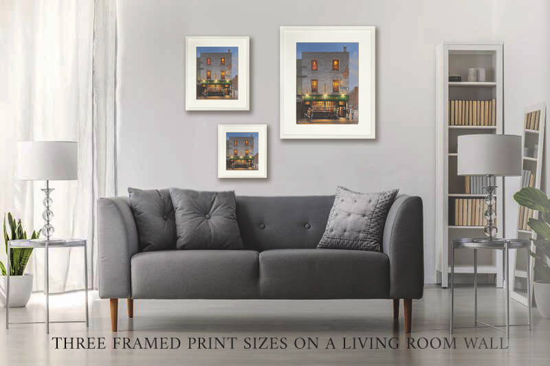 Three examples of sizes of framed prints on a wall