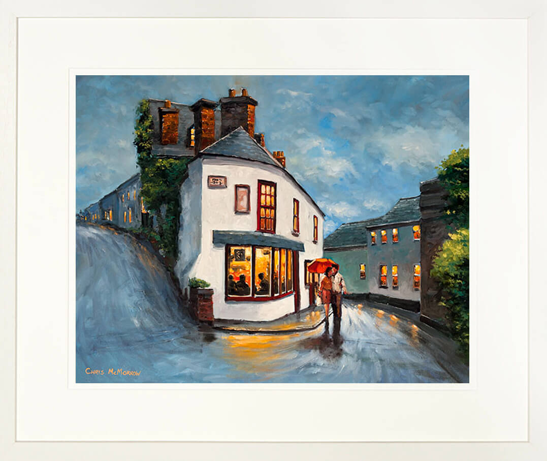 A framed print of a painting of two people walking under an umbrella by a pub in Kinsale town , County Cork