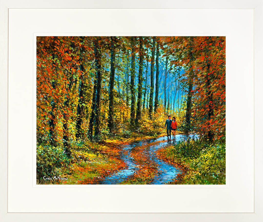 A framed print of a painting of two people walking among the fallen leaves in a wood in autumn