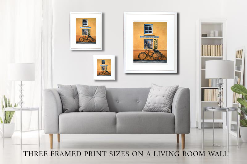 3 sizes of prints on a living room wall