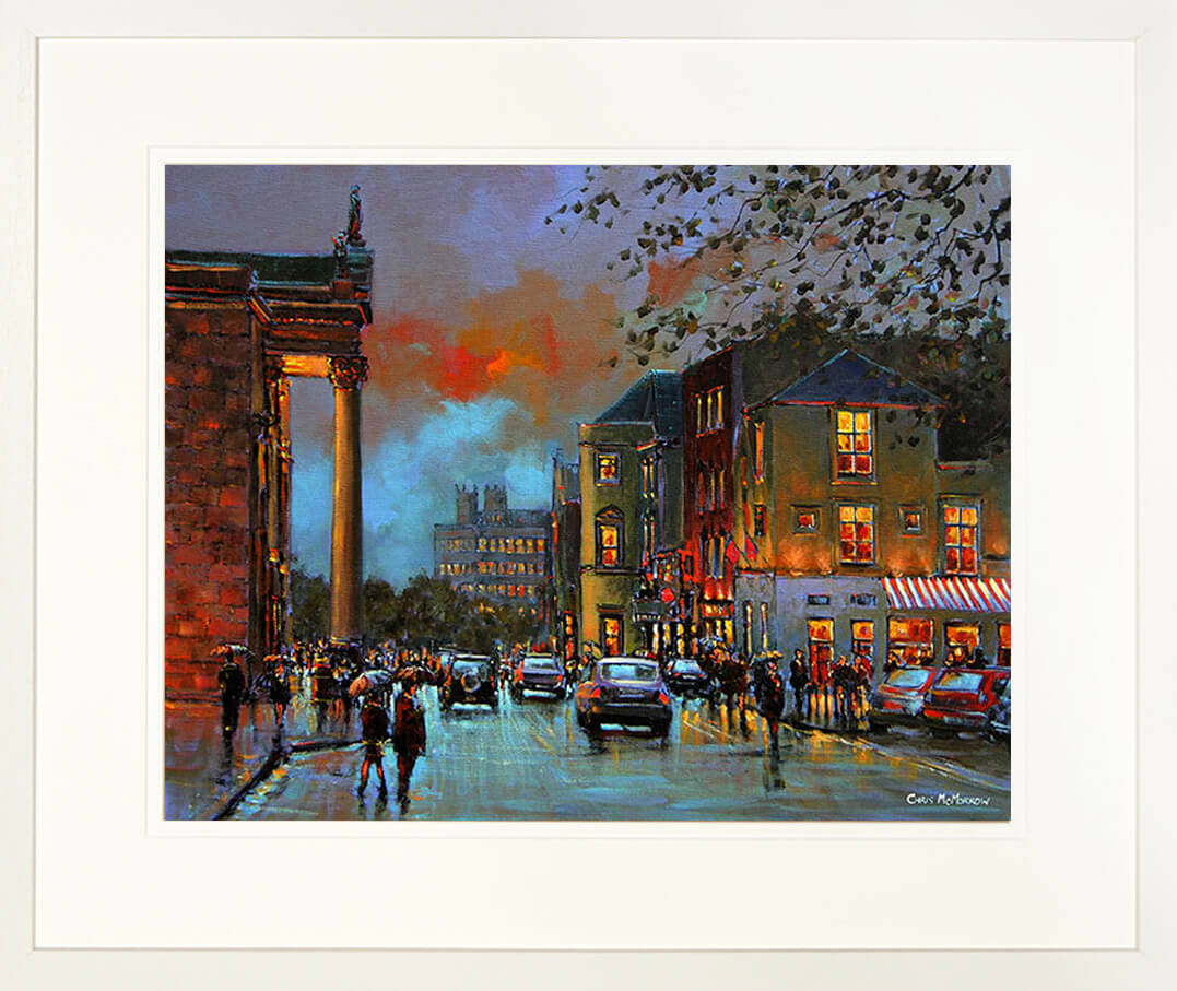A framed print of a painting of people out and about with umbrellas in Limerick city centre