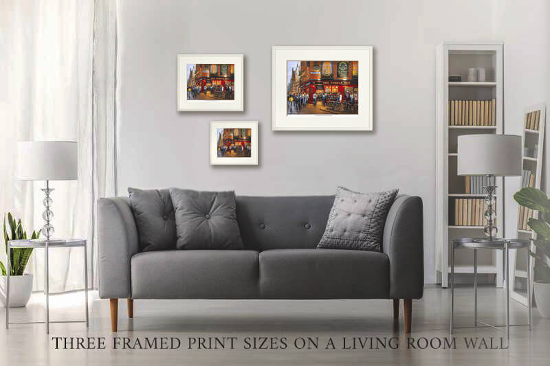 Three framed NFL prints on a wall 