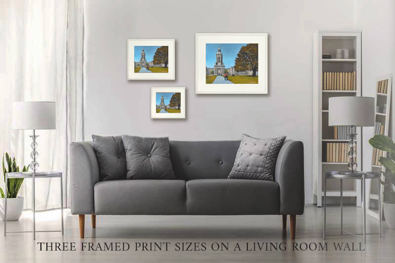 An image of three sizes prints of Trinity College on a wall