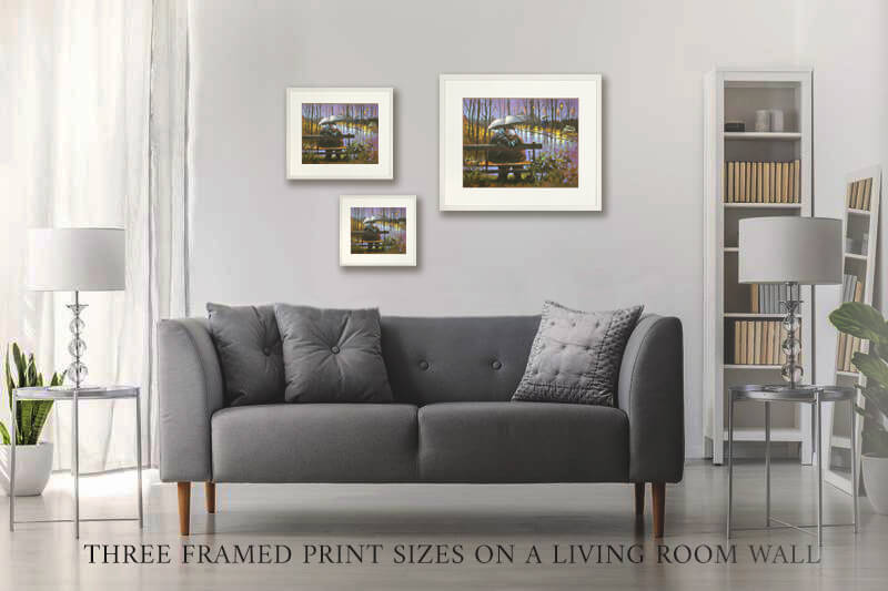 Three framed print sizes on a living room wall