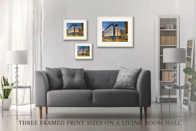 Living room with a gray sofa and three framed prints on the wall.