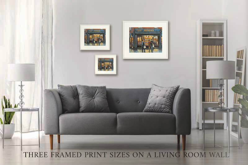 Three framed prints of a Dublin antique shop on a living room wall