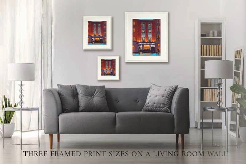 three framed prints on a living room wall