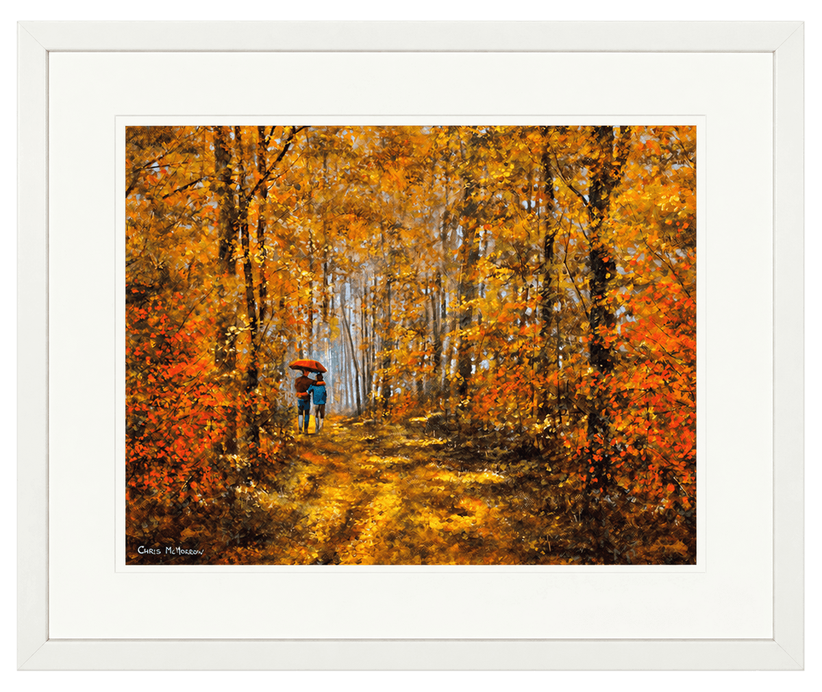 A framed art print featuring an impressionistic painting of a person with an umbrella walking down a forest path surrounded by vibrant orange and yellow autumn foliage, presented with a wide white mat board and white frame.