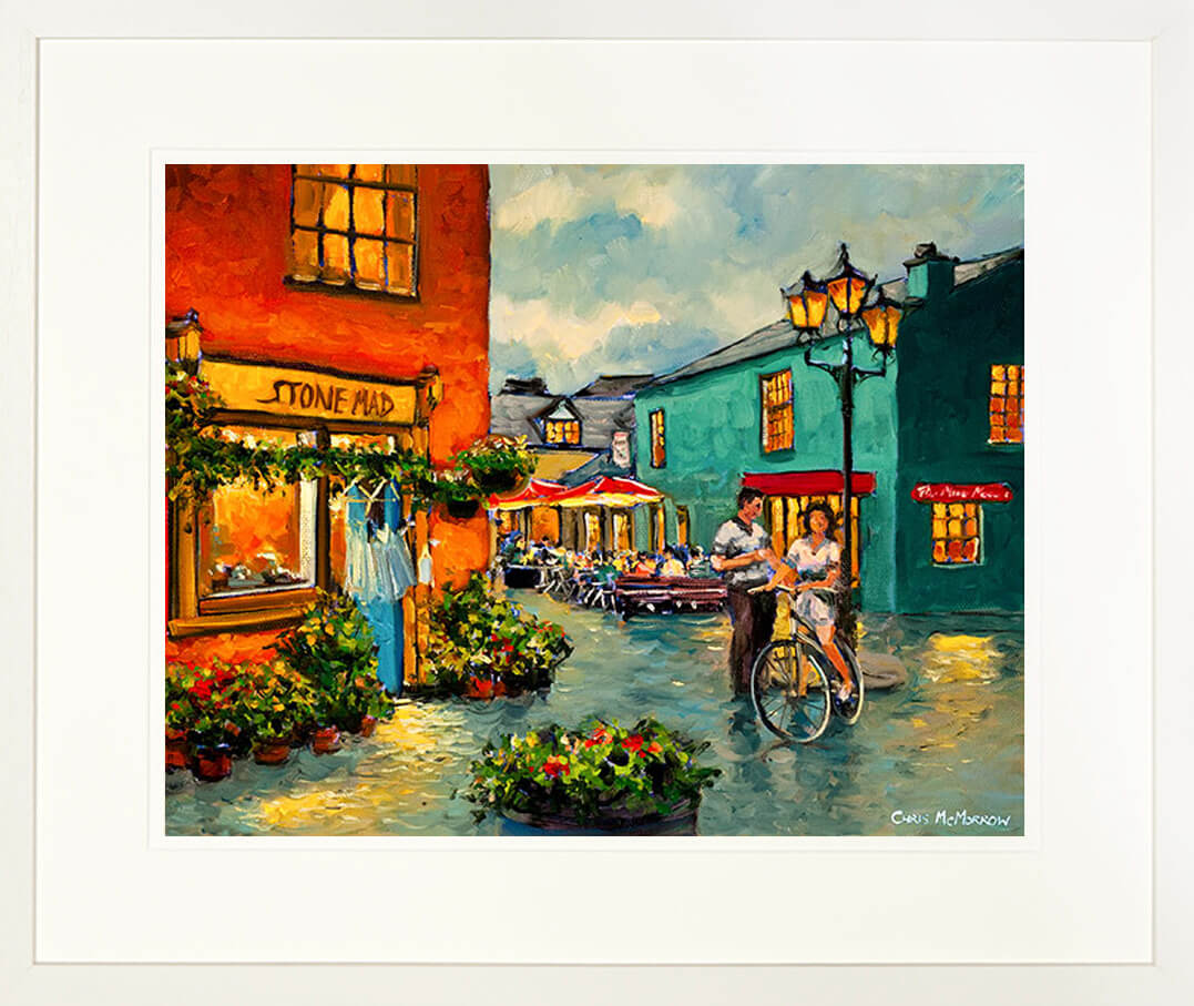 A framed print of a painting of a man and a woman talking at the Milk Market, Kinsale.