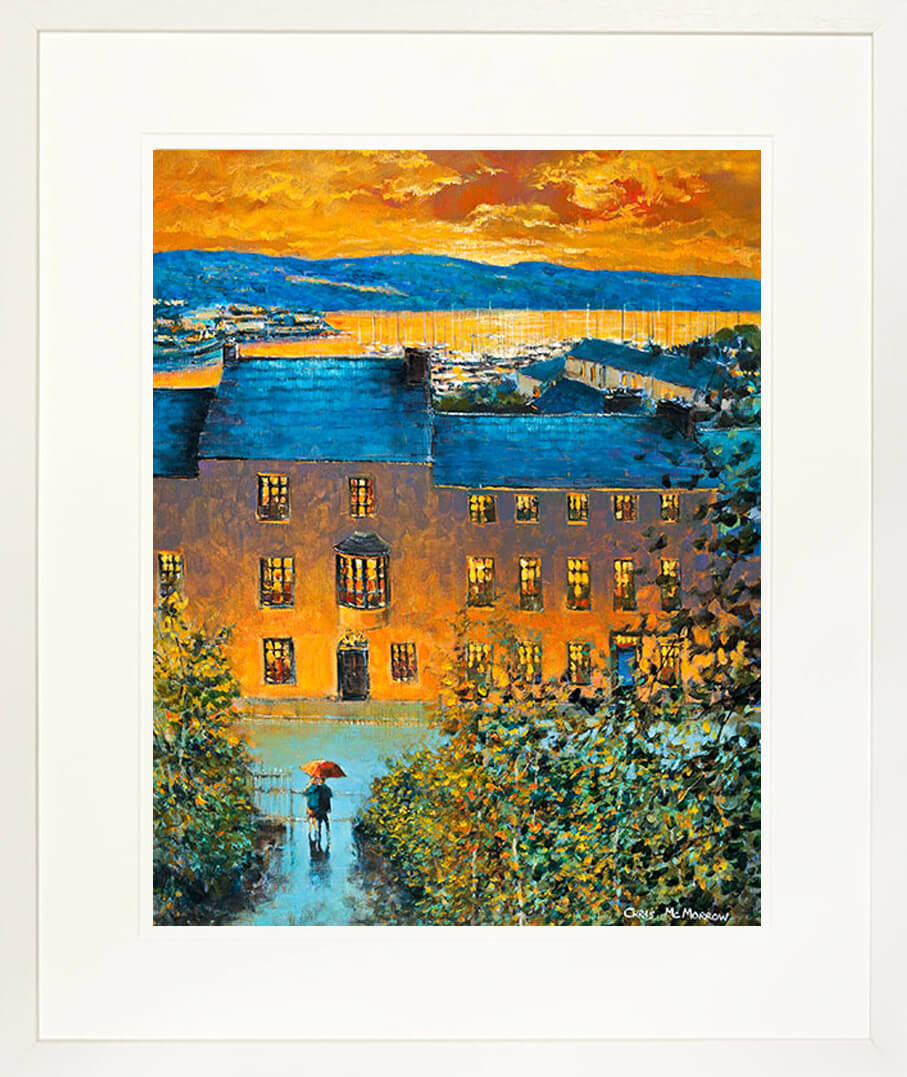 A framed print of a painting of a view from high above the town of Kinsale, Co Cork as the sun is setting