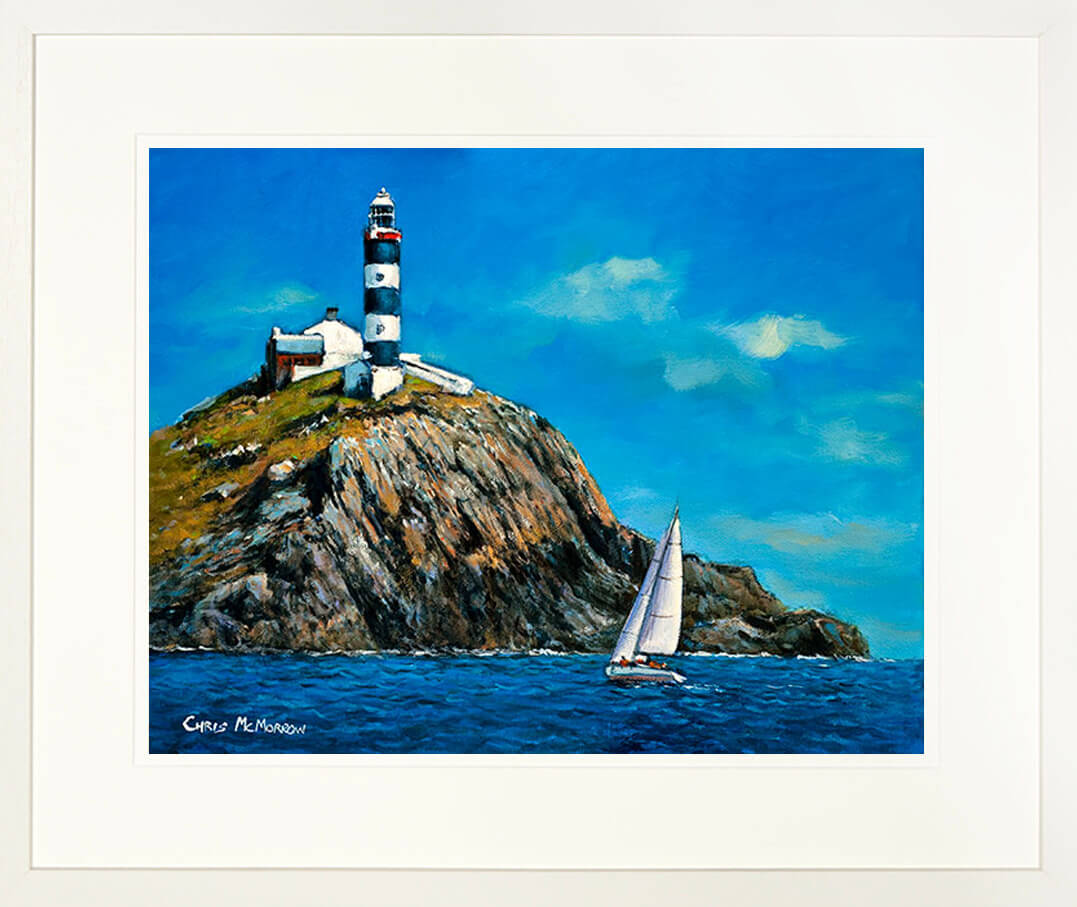 A framed print of a seascape painting of a sailboat rounding the Lighthouse on the Old Head of Kinsale