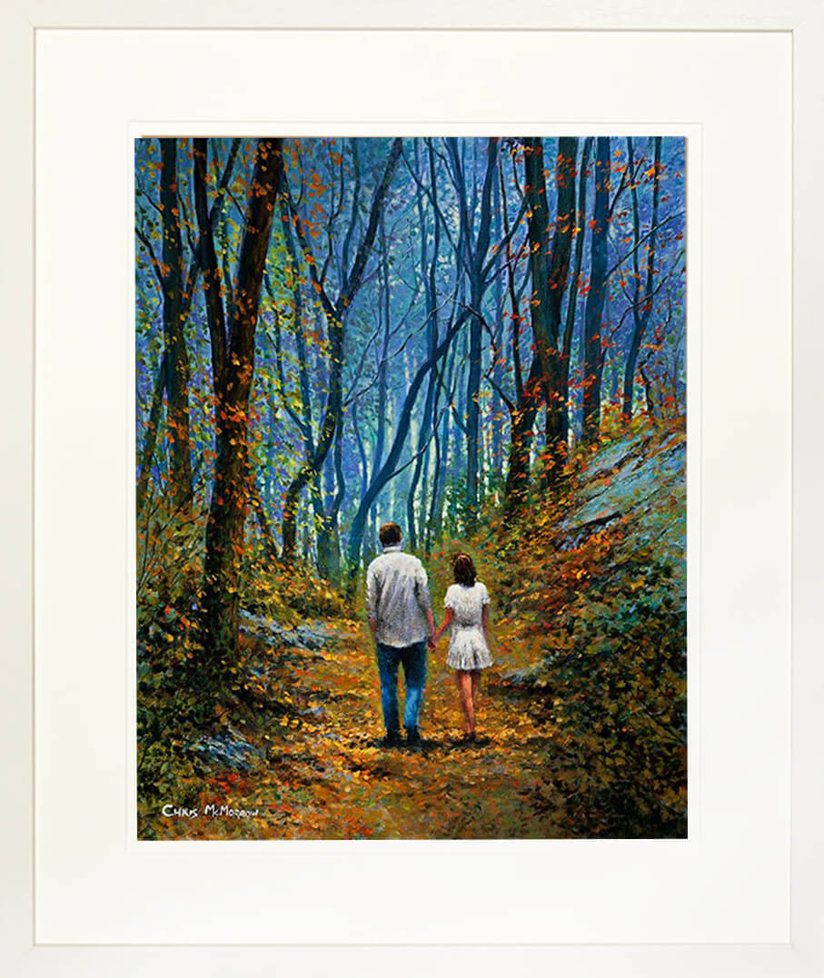 A framed print of a painting of a young couple walking on a path in the forest