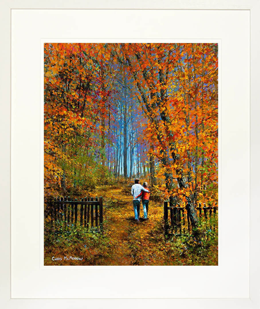 A framed print of a painting of two people walking on a path in a forest in Autumn
