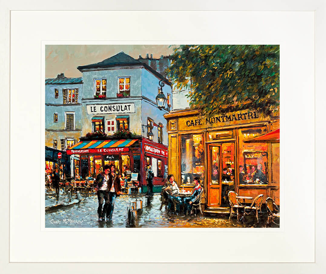 A framed print of a painting of cafes in the Montmartre area of Paris, France