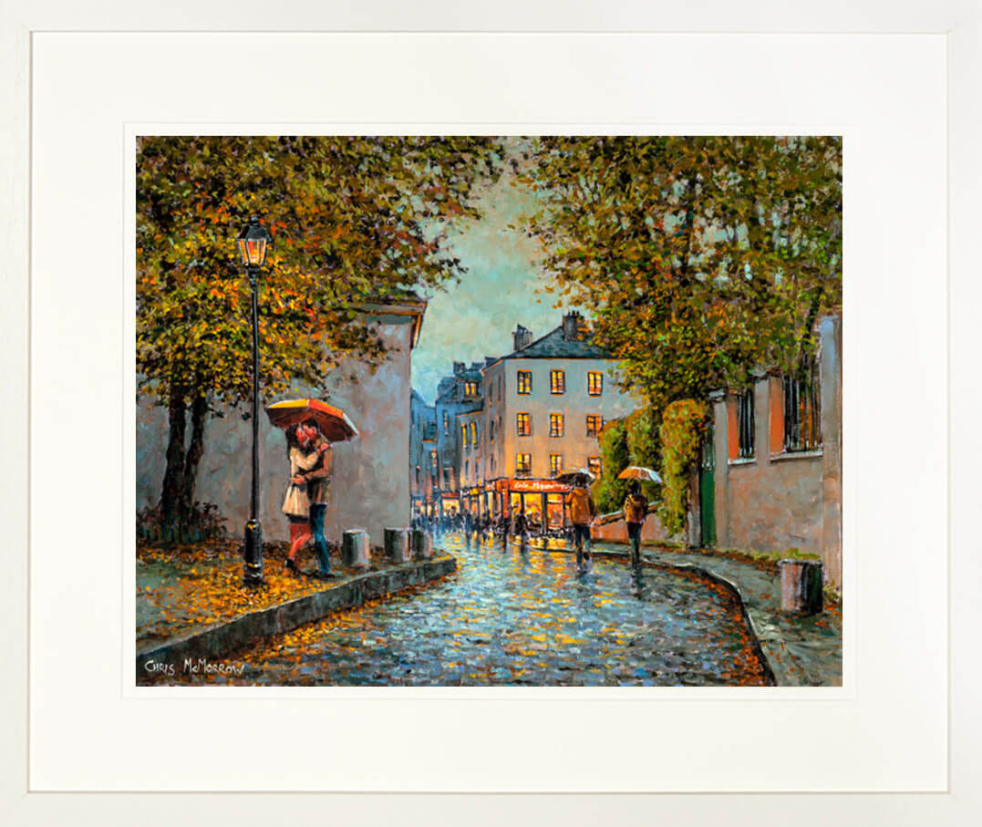 A print in a frame of a painting called Parisien Kiss which was painted in the Montmartre area of the city of Paris, France