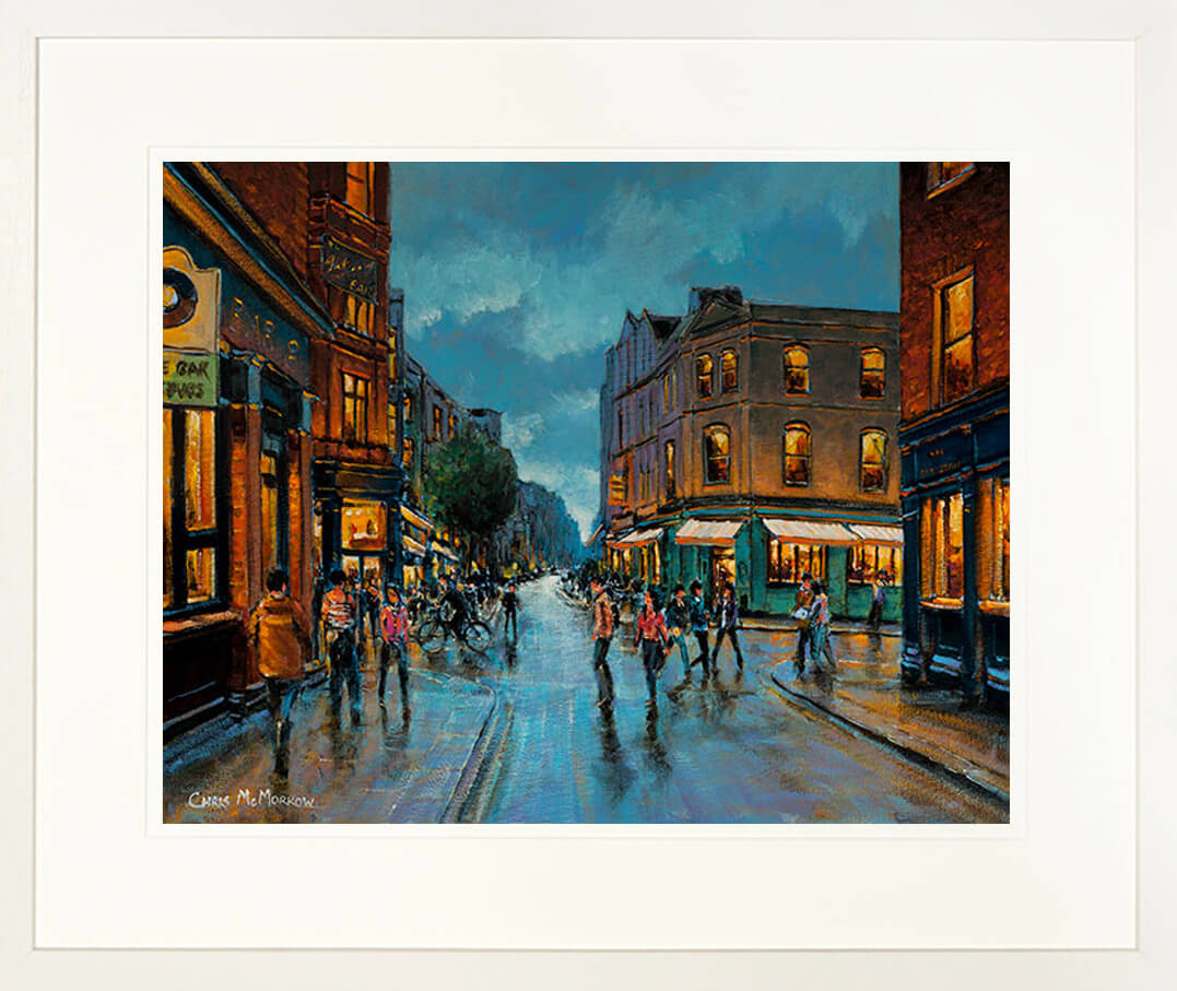 A print of a painting of South William Street, Dublin mounted in a cream limed frame