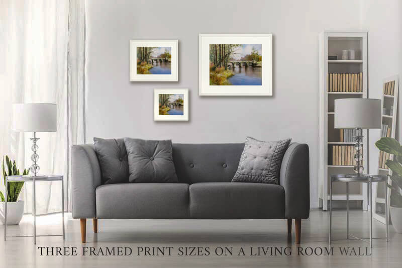 Gray sofa in a living room with three framed prints of Alexandra bridge on the wall.