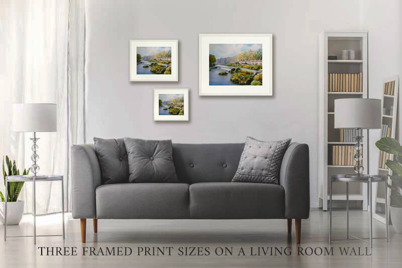 PHOTO OF THE THREE framed PRINT SIZES ON A LIVING ROOM WALL