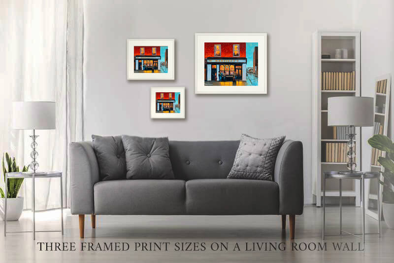 three framed Hartigans prints on a wall