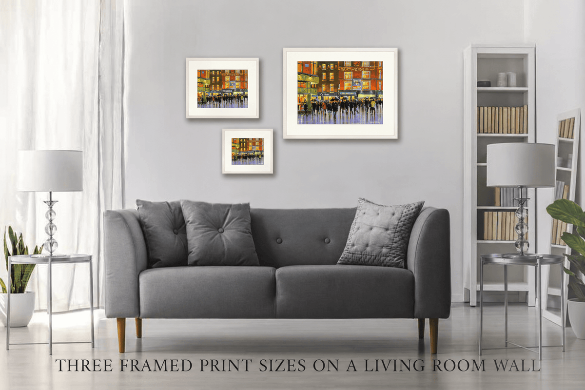 Three framed print sizes of Top of Grafton Street, Dublin on a living room wall