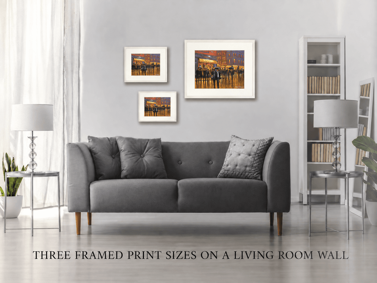 Three framed print sizes of Rain at Butlers Café, South William Street, Dublin on a living room wall
