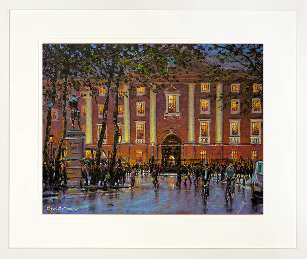A framed print of a painting named Trinity Rain which is locatedin College Green, Dublin city, Ireland