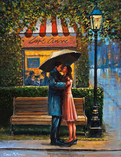 A couple embrace under an umbrella outside the Cafe Amore. Paris